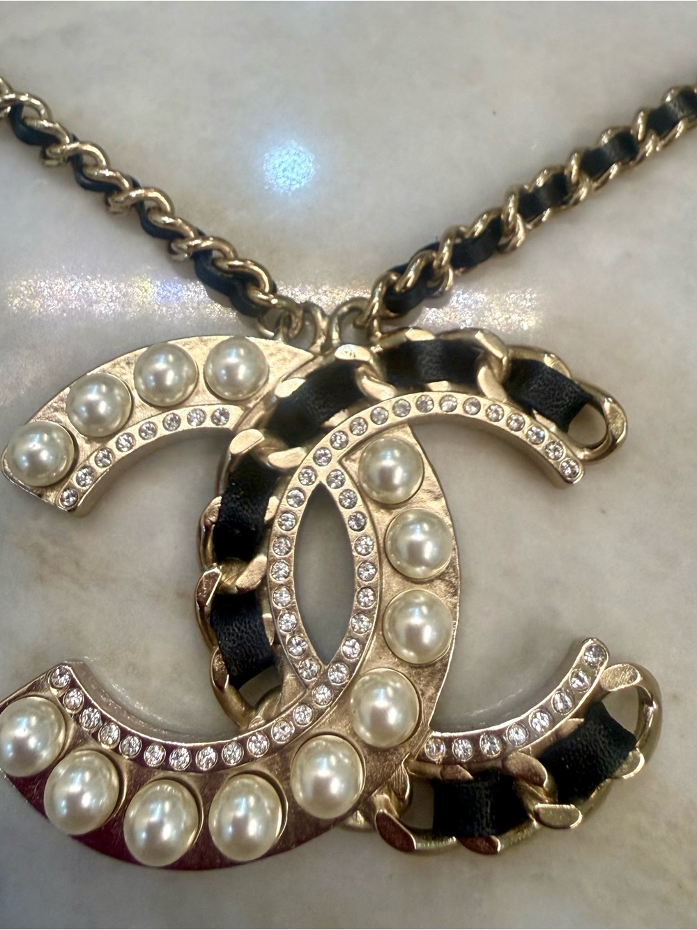 CHANEL Gold-Tone CC Pendant Necklace with Pearls & Black Leather Weave